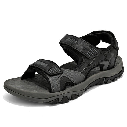Graue Outdoor-Sandale für Herren mit verstellbaren Klettverschlüssen, rutschfester Sohle und robustem Design. Ideal für Wandern und Freizeit.