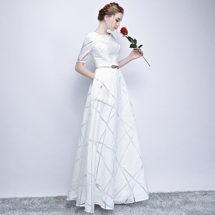 Frau in elegantem weißen Abendkleid mit Gürtel, hält rote Rose. Perfekt für Hochzeiten, formelle Anlässe. Eleganz, Mode, Abendgarderobe.