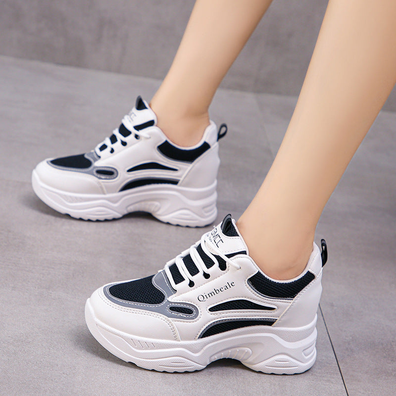 Damen Sneaker mit dicker Sohle, schwarz-weiß, sportlich, modern, bequem, ideal für Freizeit und Sport, auf grauem Boden.