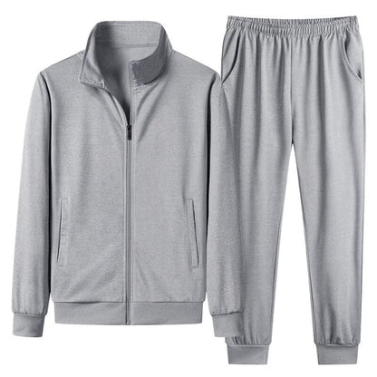 Grauer Trainingsanzug für Herren, bestehend aus Jacke mit Reißverschluss und elastischer Hose. Sportbekleidung, bequem, modern, Freizeitmode.