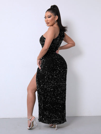 Frau in schwarzem, glitzerndem Abendkleid mit hohem Beinschlitz und weißen High Heels vor weißer Wand. Elegante Abendmode, glamouröser Look.