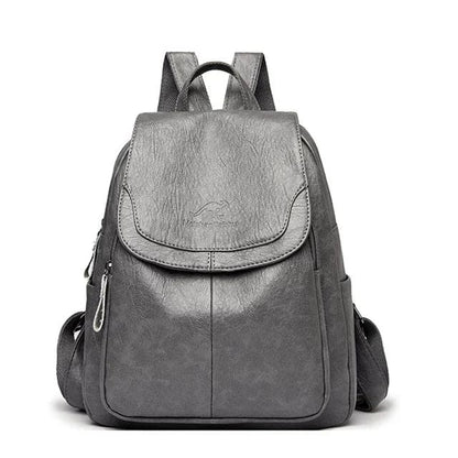 Grauer Leder-Rucksack mit Reißverschlüssen und verstellbaren Trägern, ideal für Damen. Stilvoller, praktischer Tagesrucksack für Schule oder Arbeit.