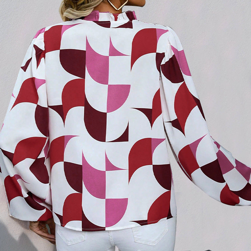 Frau trägt Bluse mit geometrischem Muster in Rot- und Pinktönen, Rückansicht. Modische Damenbekleidung, stilvolles Design, langärmlig.