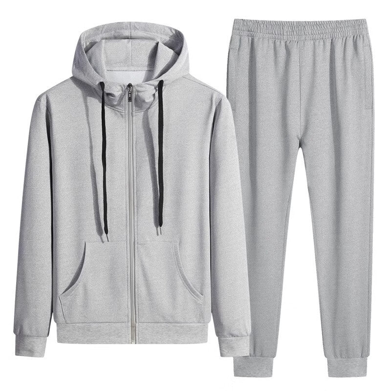 Grauer Jogginganzug mit Kapuzenpullover und Jogginghose, ideal für Sport und Freizeit. Bequeme Passform, Reißverschluss, Kordelzug, Taschen.