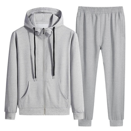 Grauer Jogginganzug mit Kapuzenpullover und Jogginghose, ideal für Sport und Freizeit. Bequeme Passform, Reißverschluss, Kordelzug, Taschen.