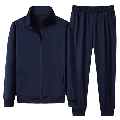 Dunkelblauer Trainingsanzug für Herren, bestehend aus Jacke mit Reißverschluss und elastischer Hose. Sportbekleidung, Freizeitmode, Herrenmode.