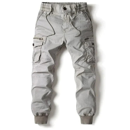 Graue Cargo-Hose für Herren mit elastischem Bund und Bündchen, mehreren Taschen, ideal für Outdoor-Aktivitäten und Freizeitkleidung.